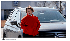 woman standing in front of VW car