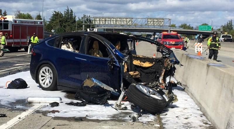 Rescue workers attend the scene where a Tesla electric SUV crashed into a barrier on U.S. Highway 101 in Mountain View